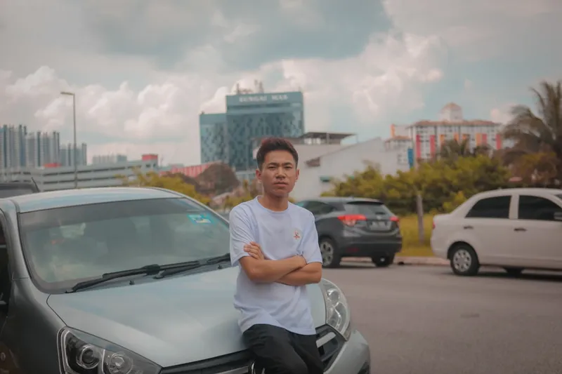 A man sitting on the hood of a car